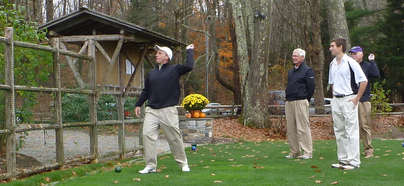 One of the Sunday Morning Group's many playoff formats: wrong-handed throw over the fence from the first tee to the practice green. Corey (throwing), Rick, Nick, Stan. Notice that Stan is practicing--a possible rules violation. October, 2012.
